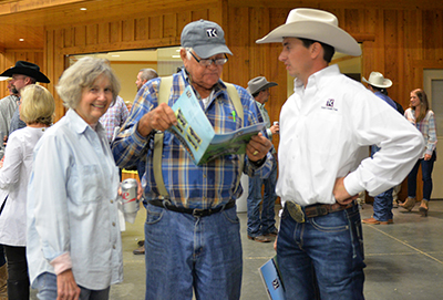 Town Creek Farm bull buyers Iris and Bill Purvis, Mississippi, discuss potential bull purchases with Clint Ladner of Town Creek Farm prior to the bull sale.